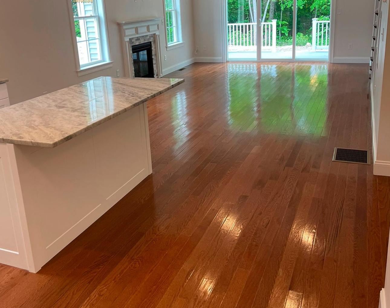 Polished hardwood floors and clean kitchen island after cleaning