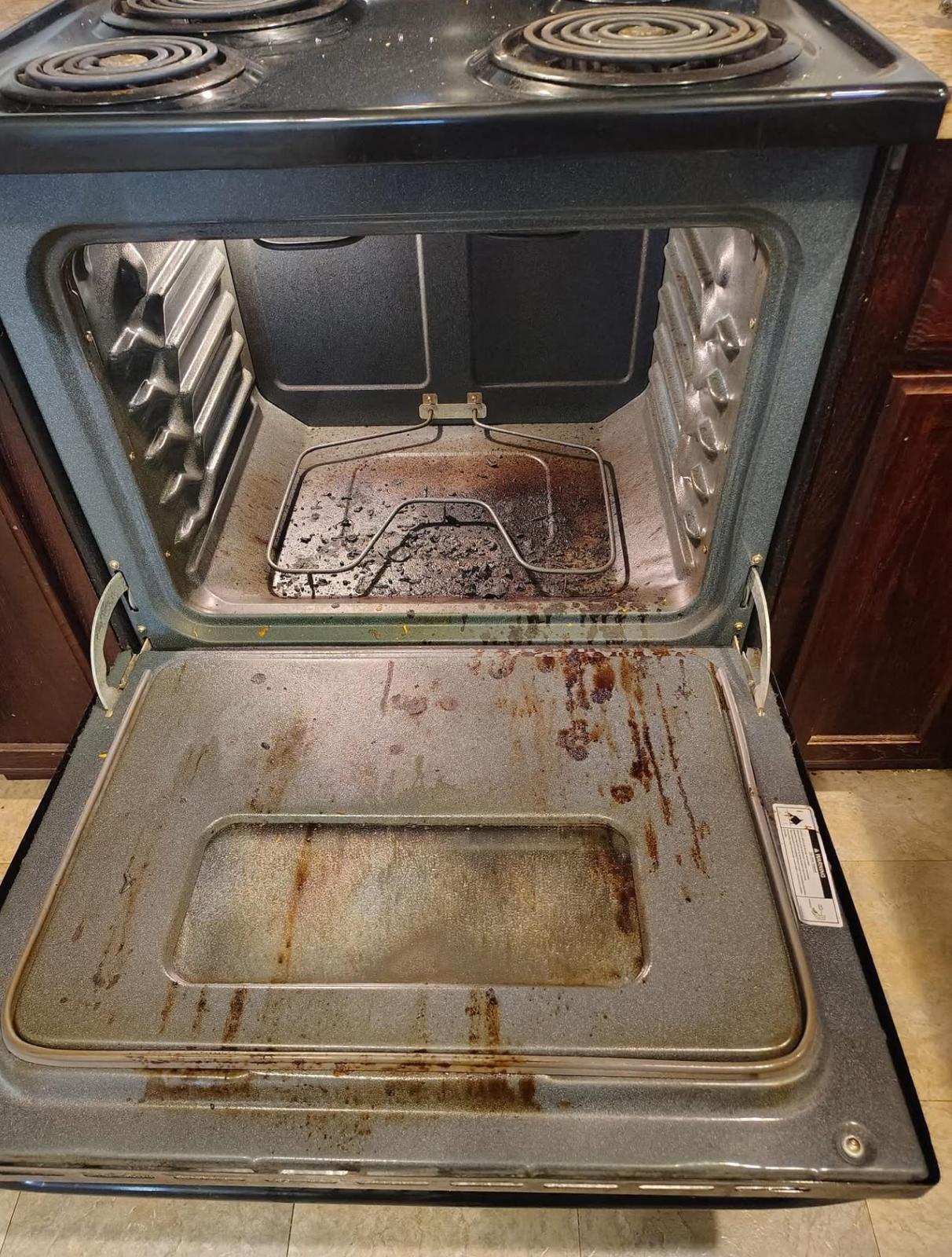 Oven with baked-on grease before deep cleaning